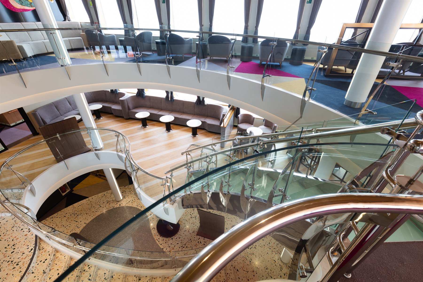 Turn-key accommodation — atrium with feature staircase and lounge decks